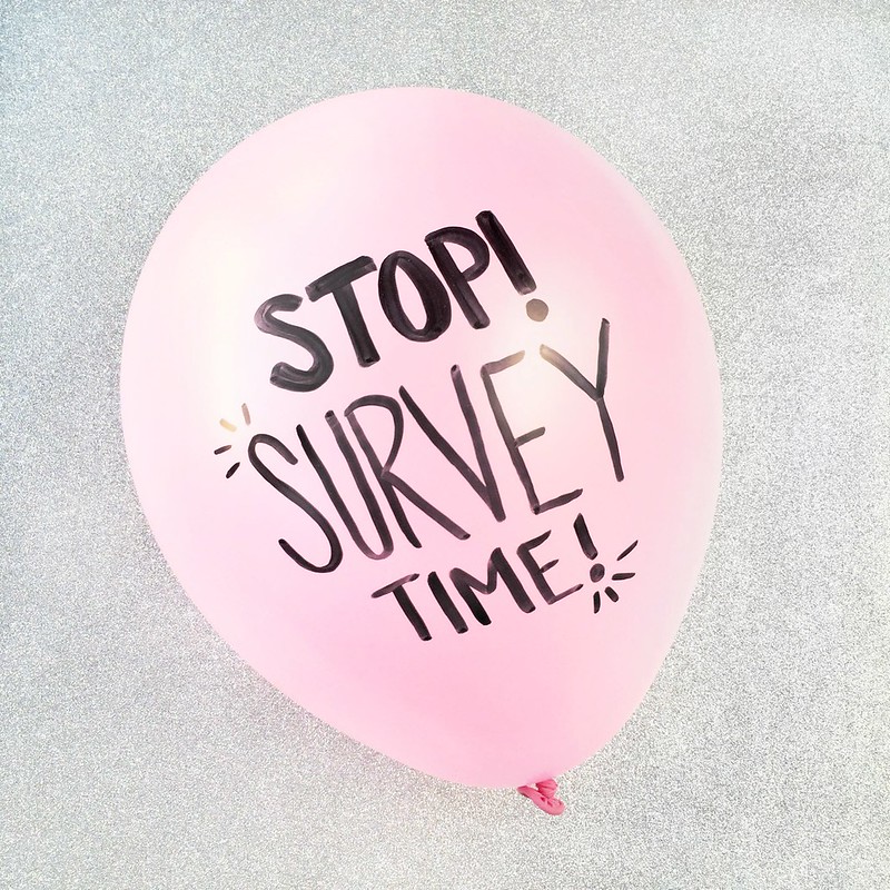 A balloon on which is written: "stop! survey time!"