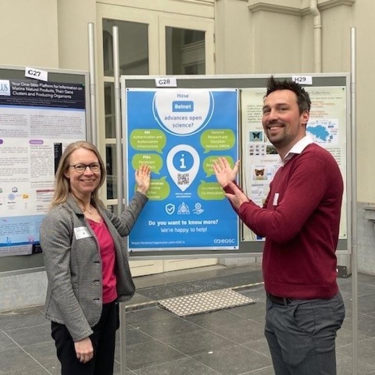 Our colleagues Niels Deriemaecker and Friederike Schröder-Pander in front of the Belnet poster during the tripartite event